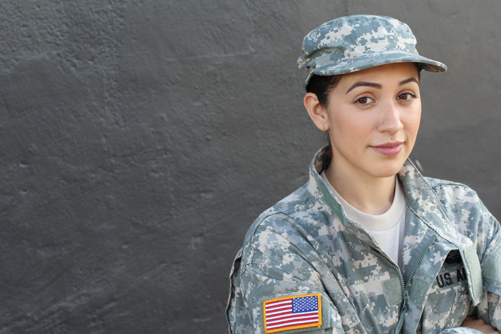 Woman in U.S Military uniform with dark stone background