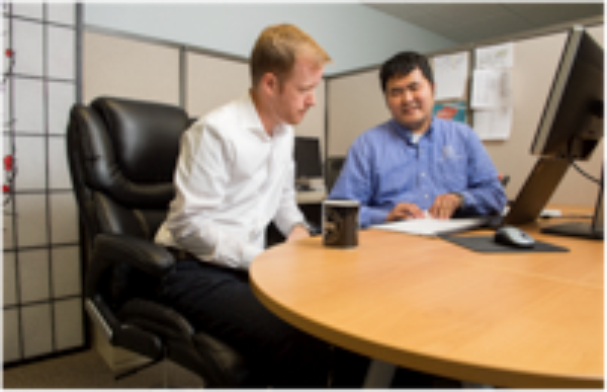 Blind Employee talking with coworker in cubicle Blind Employee talking with coworker in cubicle